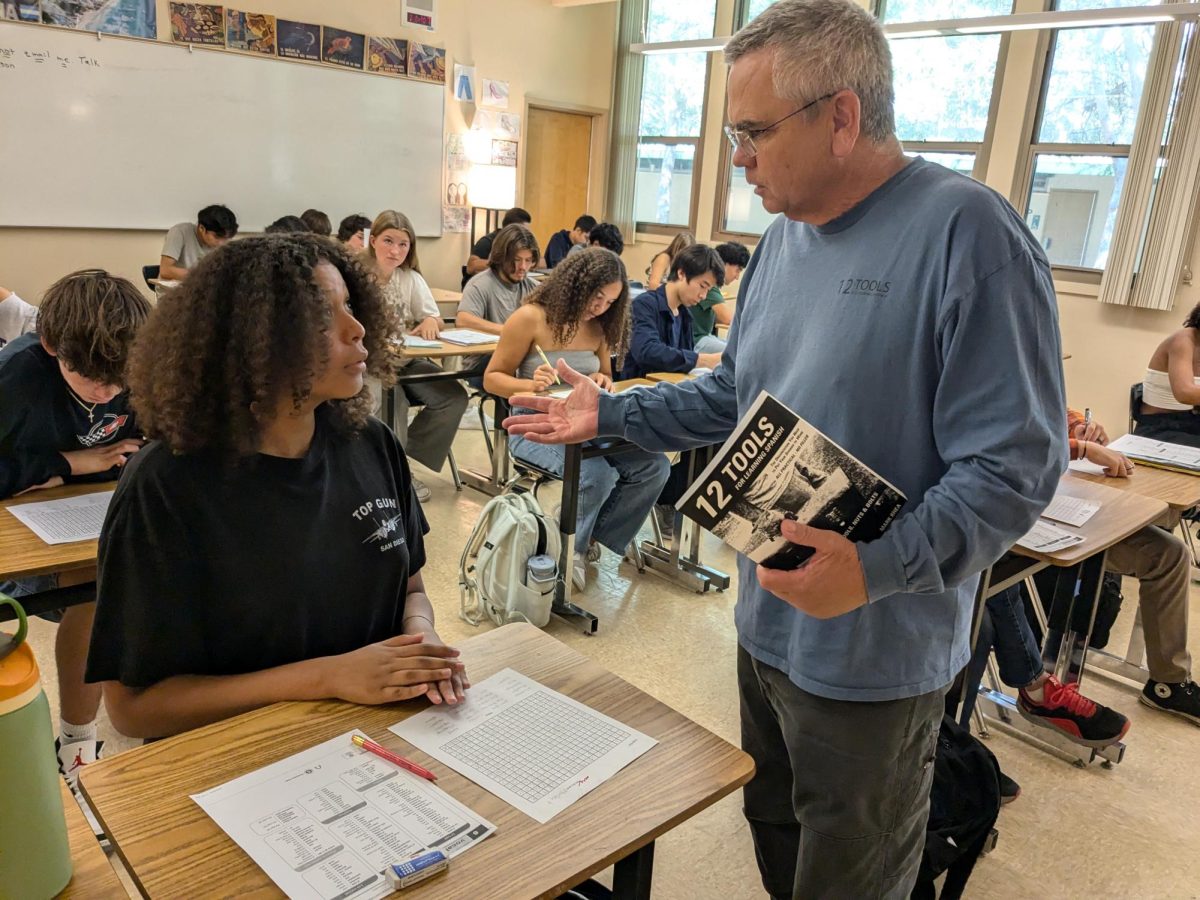 A teacher, Mr. Rhea, helping a student